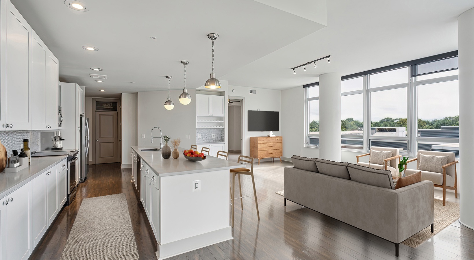 kitchen with large island and view of living room with large windows
