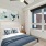 bedroom with bed wall art and large window