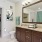 bathroom with sink and large mirror